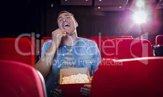 Happy young man watching a film