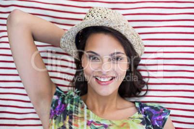 Smiling beautiful brunette lying on the blanket