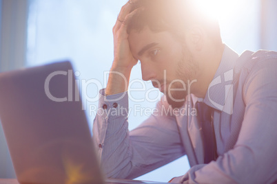 Businessman using laptop at desk