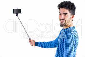 Casual man using a selfie stick