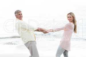 Happy couple holding hands and smiling at camera