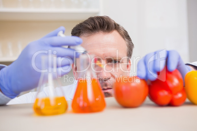 Scientist injecting vegetables
