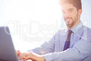 Businessman using laptop at desk