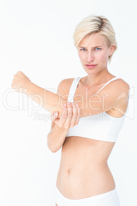 Woman with elbow pain looking at camera