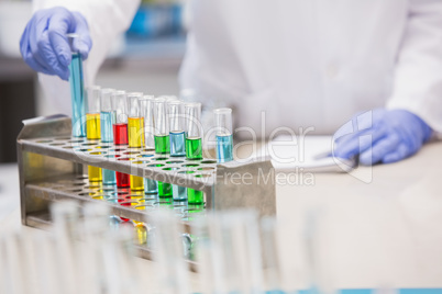 Scientist examining tubes