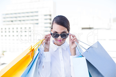 Beautiful brunette holding shopping bags