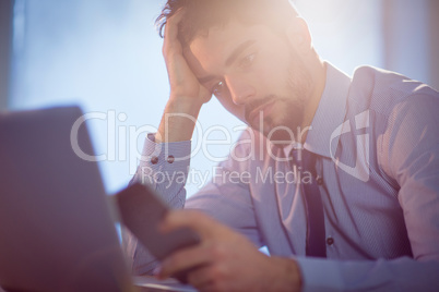 Businessman using laptop at desk