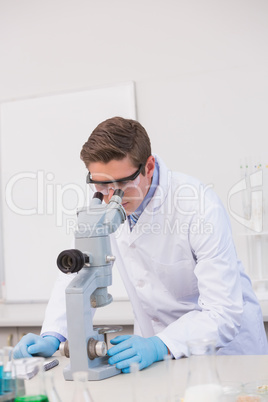 Scientist looking through a microscope