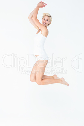 Cheerful blonde woman jumping