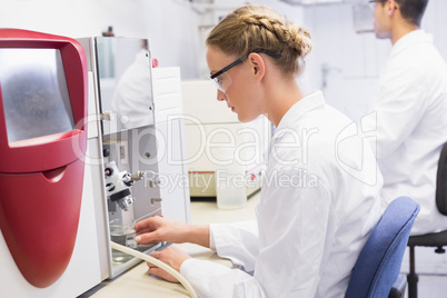 Concentrated scientists working with medical machine