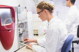 Concentrated scientists working with medical machine