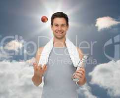 Composite image of smiling fit young man with apple and water bo