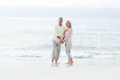 Happy couple standing by the sea