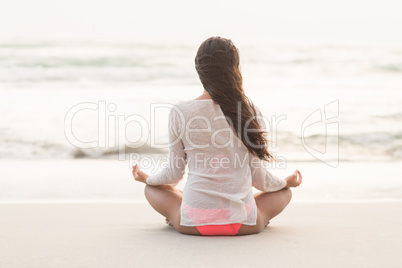 Sporty brunette sitting in lotus pose