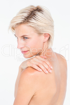 Attractive woman touching her shoulder