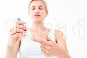 Smiling woman testing her blood glucose level