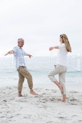 Happy couple doing yoga pose