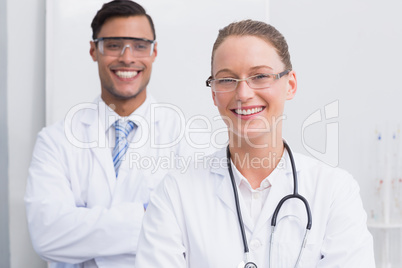 Happy scientists smiling at camera with arms crossed