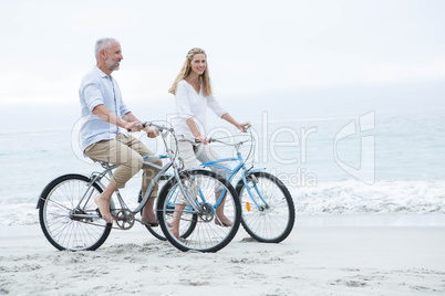 Happy couple cycling together Happy couple cycling together