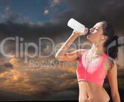 Composite image of beautiful healthy woman drinking water