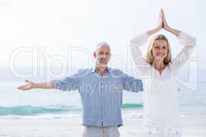 Happy couple doing yoga together