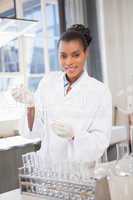 Smiling scientist working with pipette