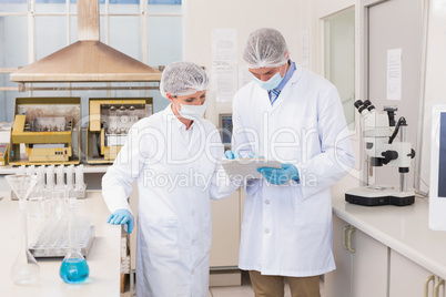 Scientists looking at clipboard