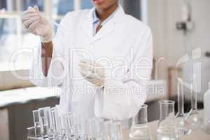 Concentrated scientist working attentively with pipette