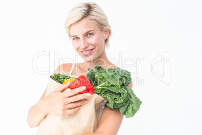 Attractive woman holding bag of vegetables