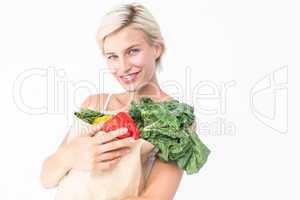 Attractive woman holding bag of vegetables