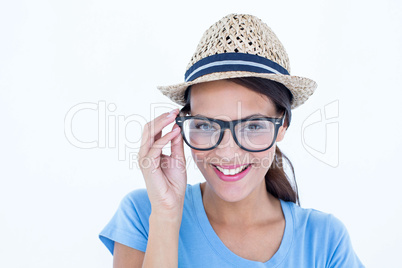 Happy brunette woman holding her eyeglasses