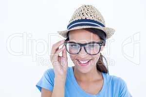 Happy brunette woman holding her eyeglasses