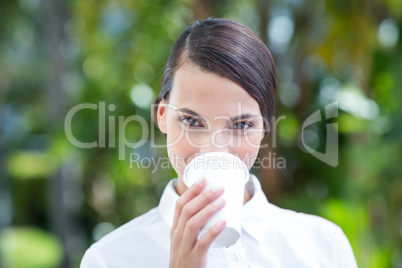 Pretty brunette drinking coffee and looking at camera