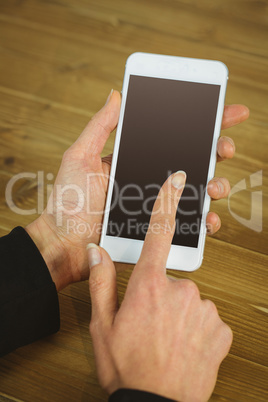 Businesswoman using phone at desk