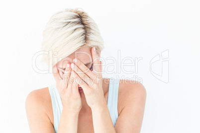 Sad blonde woman crying with head on hands