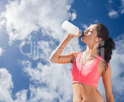 Composite image of beautiful healthy woman drinking water