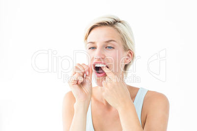 Blonde woman flossing