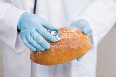 Scientist listening bread with stethoscope