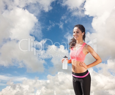 Composite image of beautiful smiling healthy woman holding water
