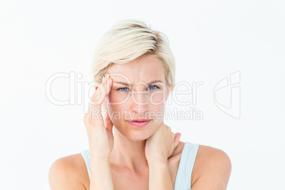 Blonde woman suffering from headache and neck ache