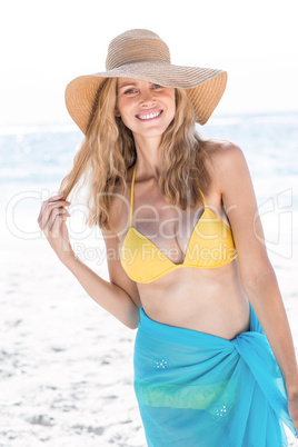 Smiling pretty blonde in bikini looking at camera