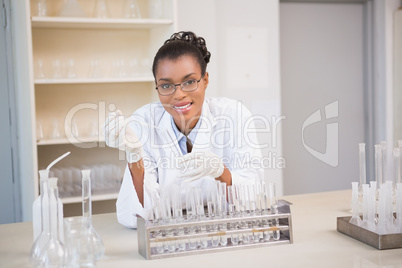 Smiling scientist working with pipette