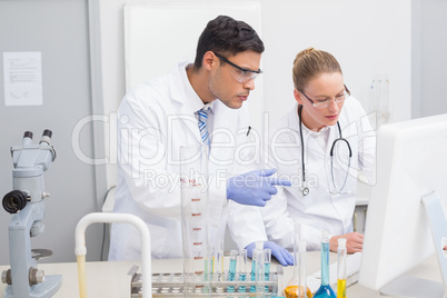 Scientists looking at computer