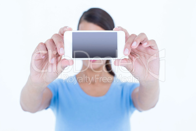 Brunette woman taking a selfie with her smartphone