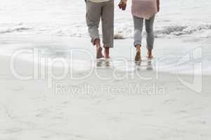 Happy couple walking by the sea
