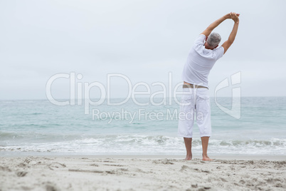 Man stretching his arms by the sea