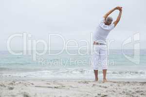 Man stretching his arms by the sea