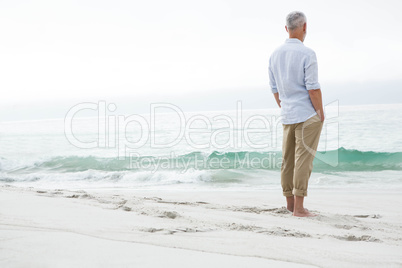 Thoughtful man standing by the sea