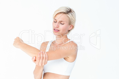 Suffering woman touching her sore elbow