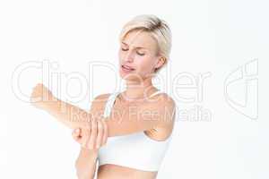 Suffering woman touching her sore elbow